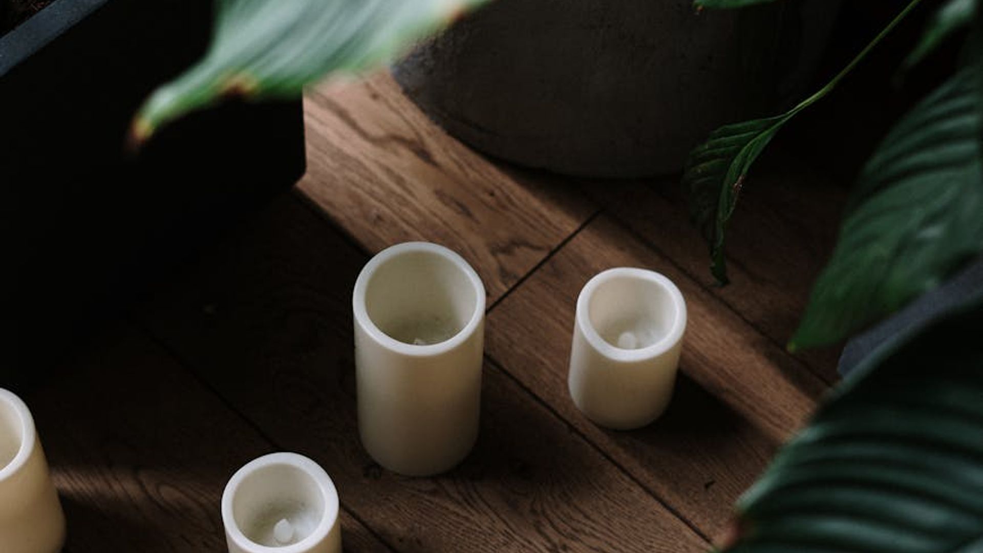 Minimalist yoga studio with soft cyan lighting and carbon textures.